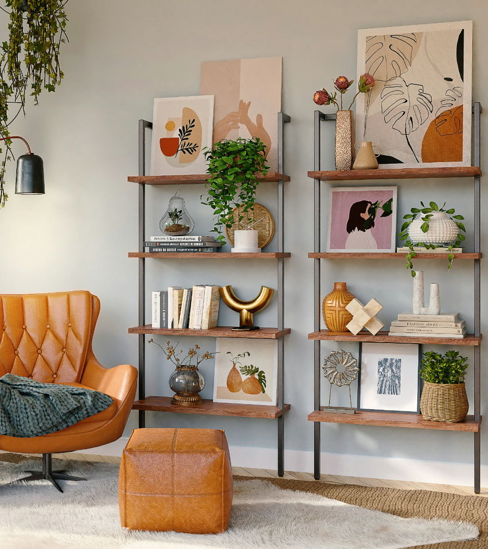 A styled living area featuring a tan leather chair, matching ottoman, and two minimalist wooden bookshelves.
